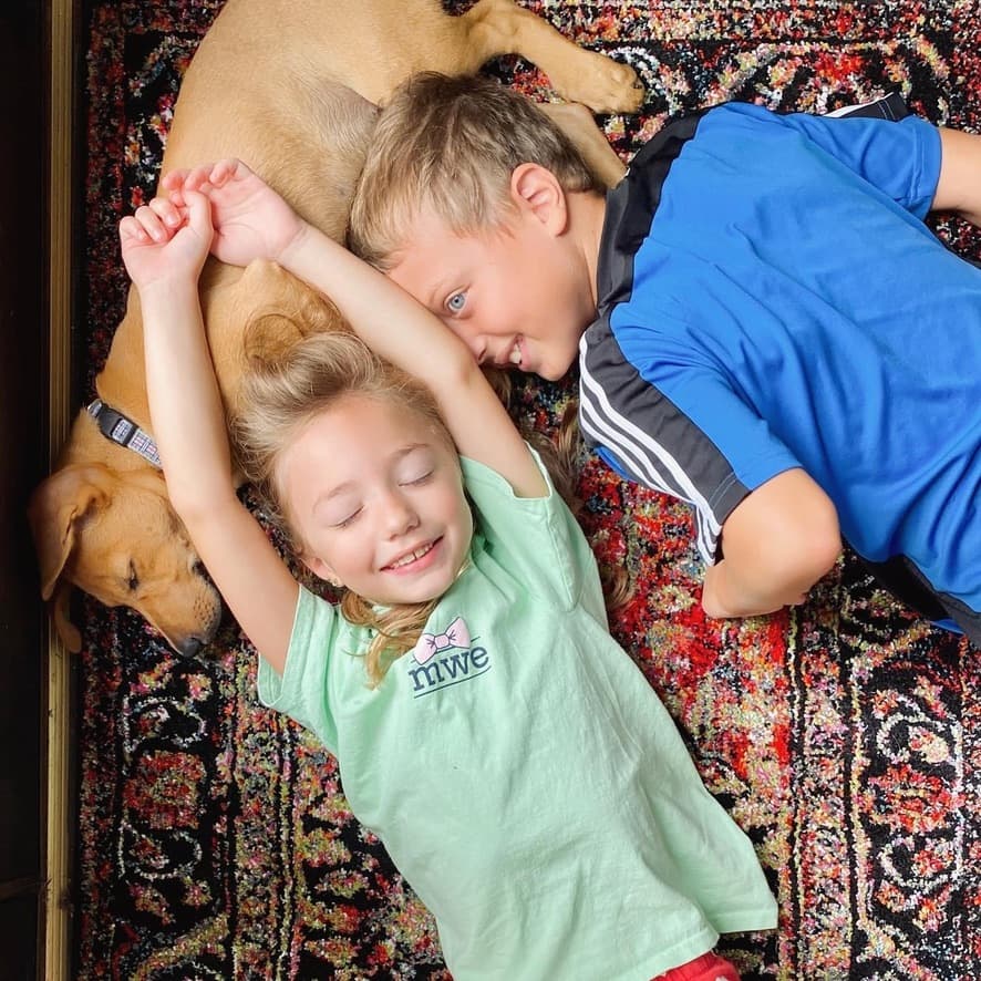 Kids and the family dog sprawled on the living room rug
